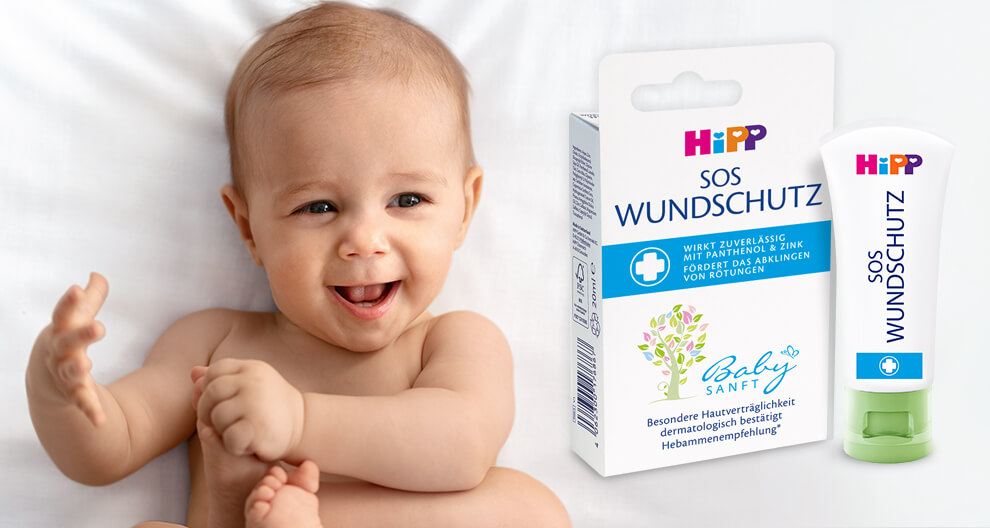 A baby is shown next to a box and tube of a medical product.